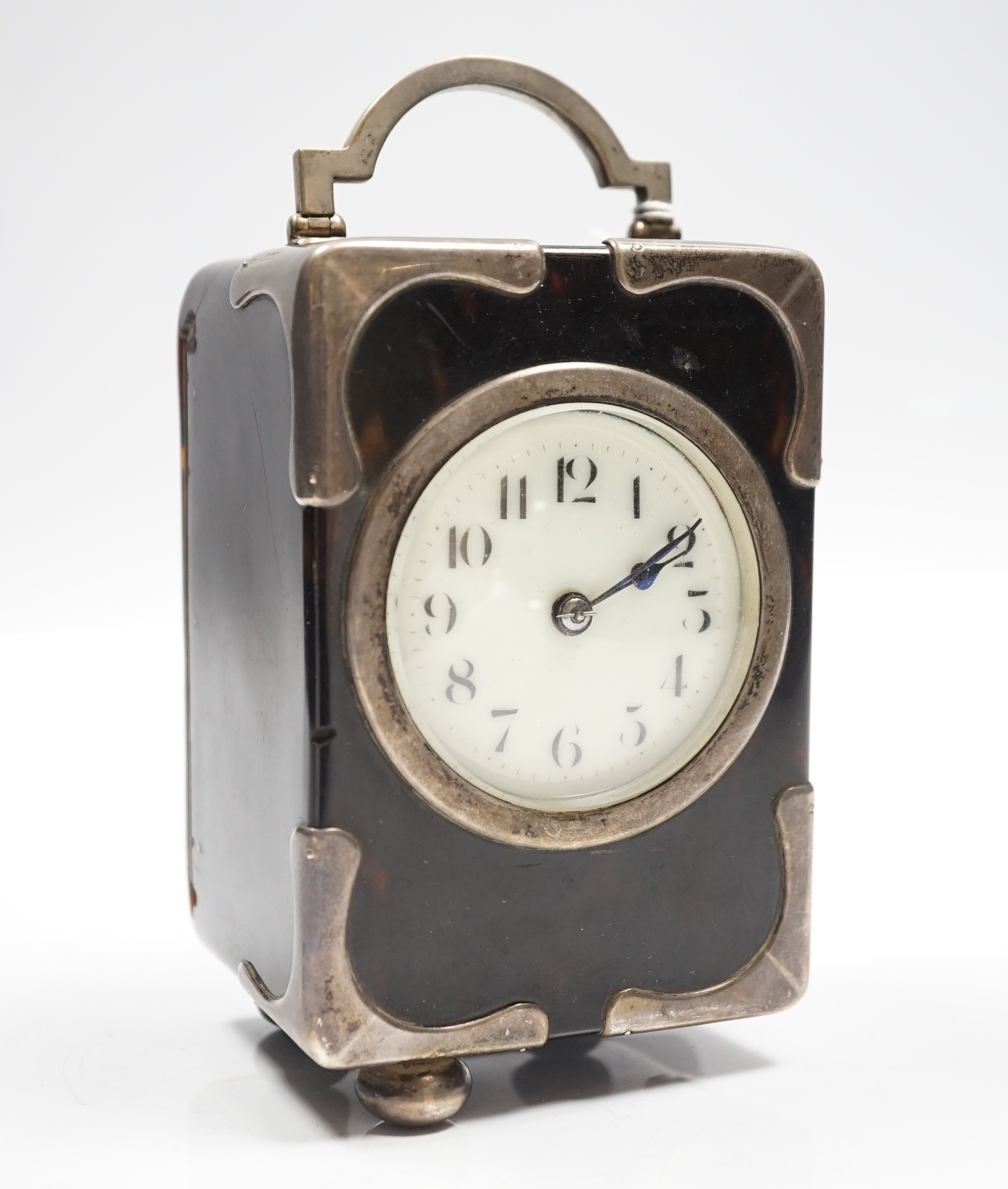 A George V silver mounted tortoiseshell cased carriage clock, with Arabic dial, chips to the case and ball foot missing, height 15cm over handle.
